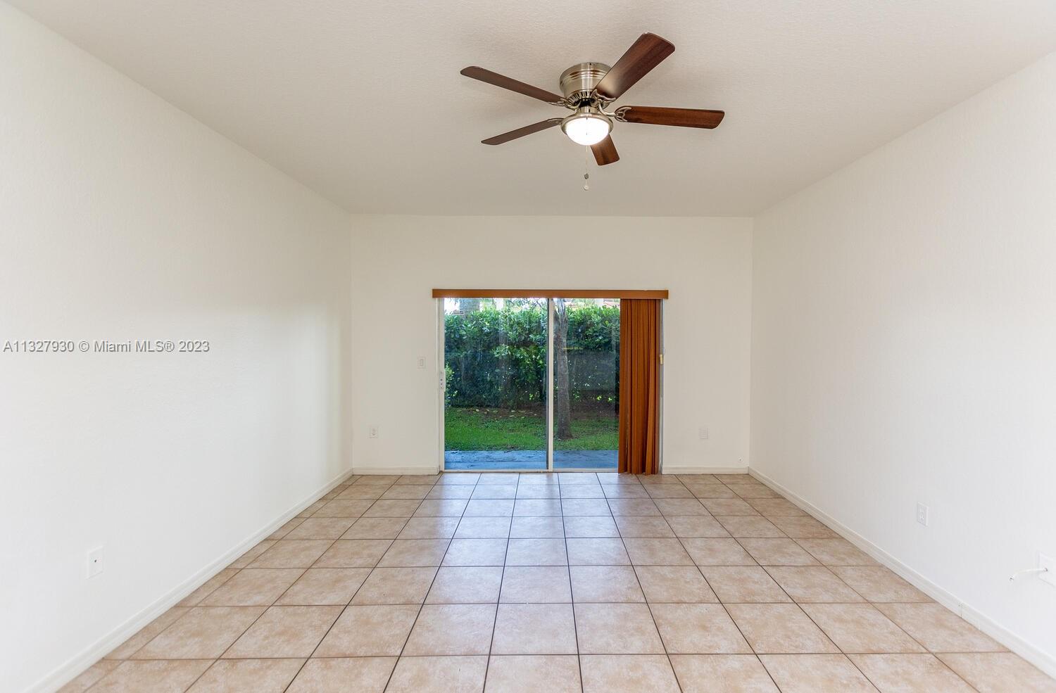 4979 Southwest 140th Terrace, Unit 8 Miramar, FL 33027 - Photo 9 of 43 an empty room with windows and fan