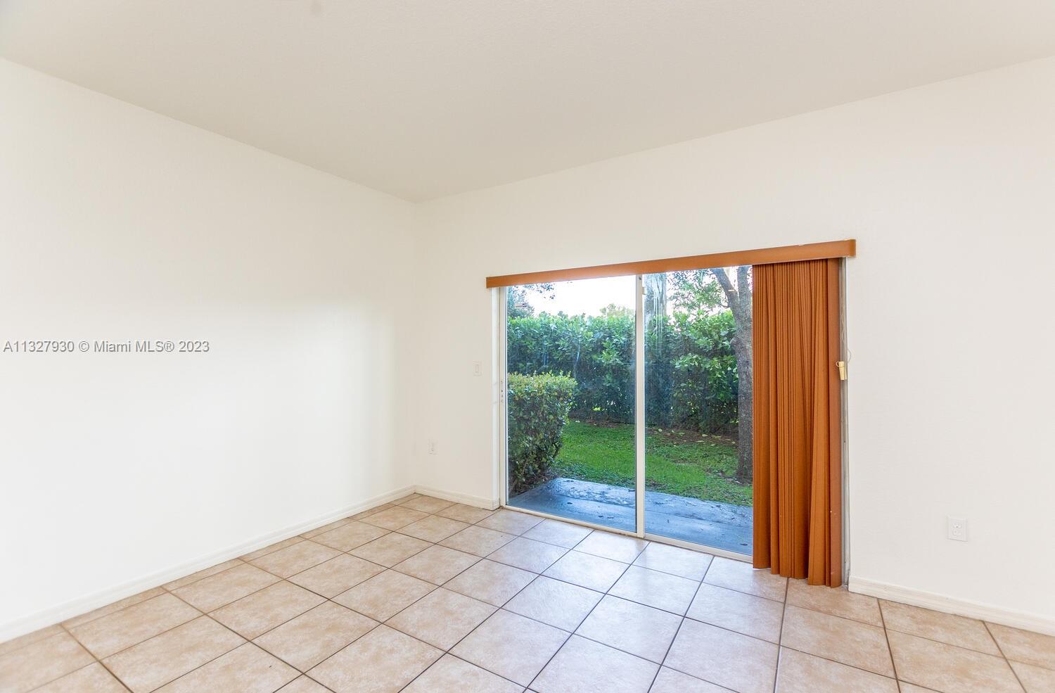 4979 Southwest 140th Terrace, Unit 8 Miramar, FL 33027 - Photo 10 of 43 a view of an empty room with window