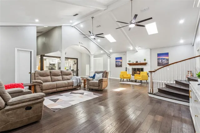 a living room with furniture and wooden floor