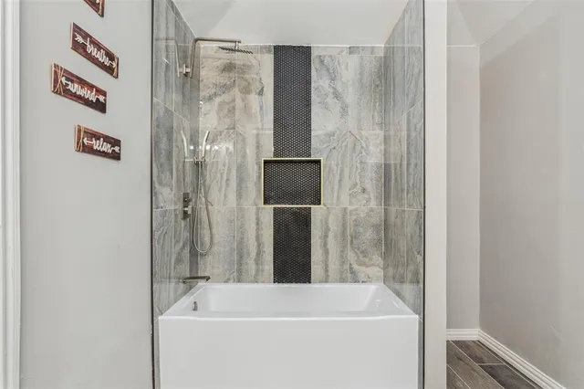 a bathroom with a bathtub and a shower