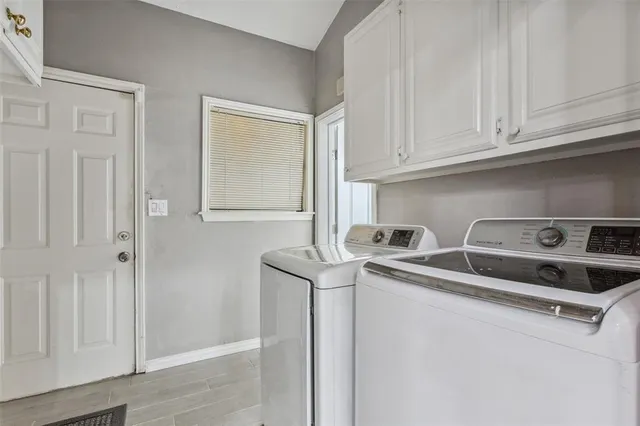 a kitchen with stainless steel appliances granite countertop a sink and a refrigerator