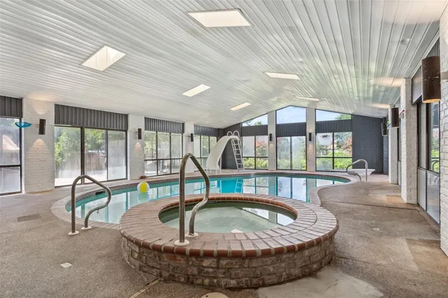 a view of a swimming pool with a lounge chairs