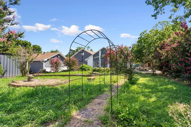a side view of a house with a yard
