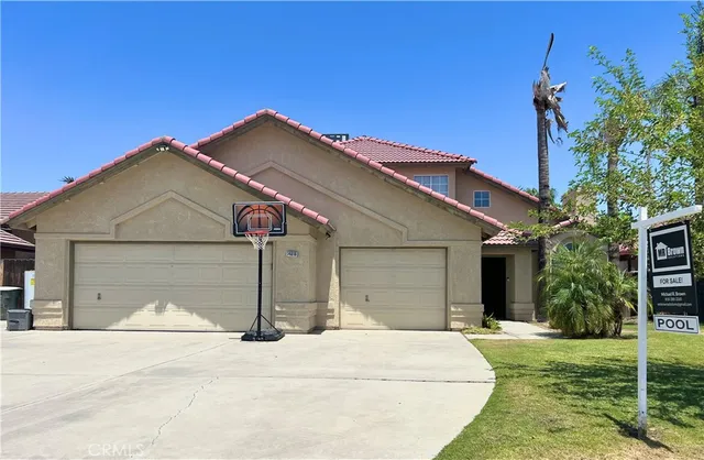 a front view of a house with a yard and garage