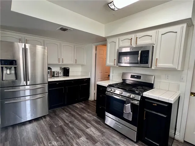 a kitchen with stainless steel appliances and wooden cabinets