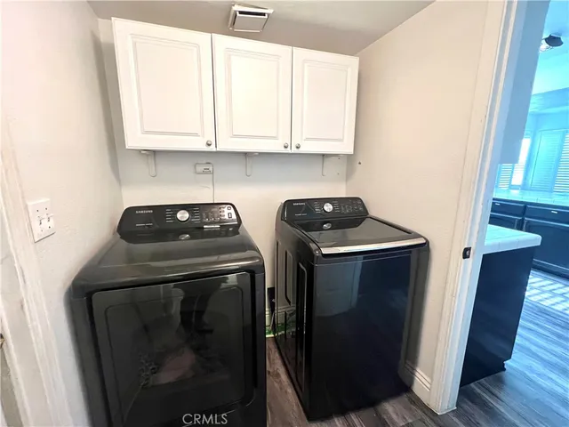 a view of a storage and utility room with washer and dryer