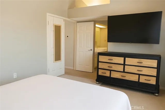 a bedroom with a bed and a flat screen tv