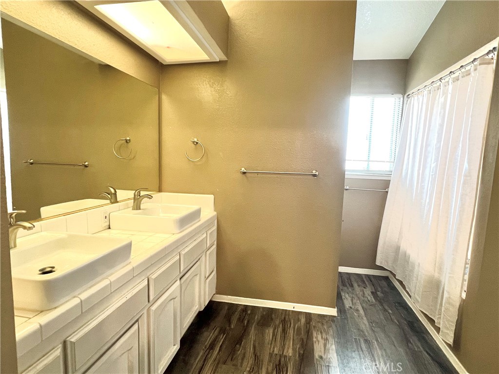 14016 Las Entradas Bakersfield, CA 93314 - Photo 19 of 25 a bathroom with a granite countertop sink and a mirror