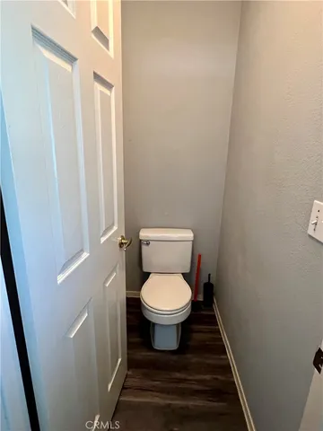 a white toilet sitting in a bathroom next to a sink