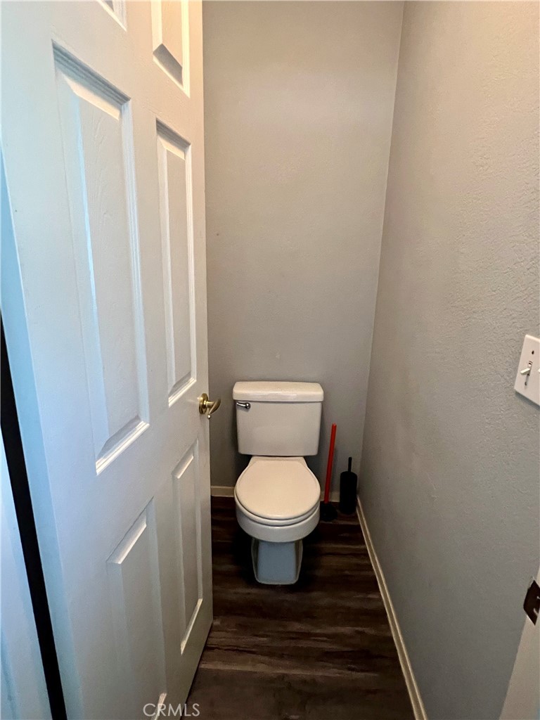 14016 Las Entradas Bakersfield, CA 93314 - Photo 21 of 25 a white toilet sitting in a bathroom next to a sink