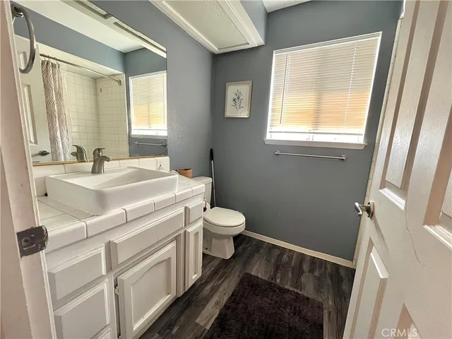 a bathroom with a sink a toilet and a mirror