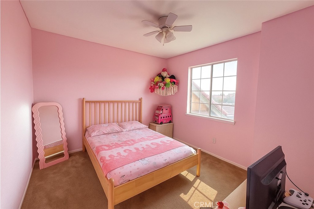14016 Las Entradas Bakersfield, CA 93314 - Photo 24 of 25 a bedroom with a bed and a chandelier