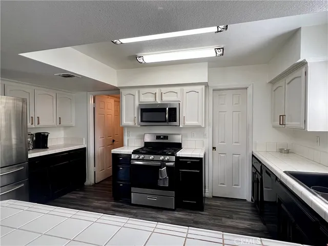 a kitchen with stainless steel appliances a stove sink and cabinets