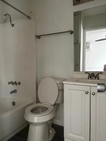 a bathroom with a toilet a sink and bathtub