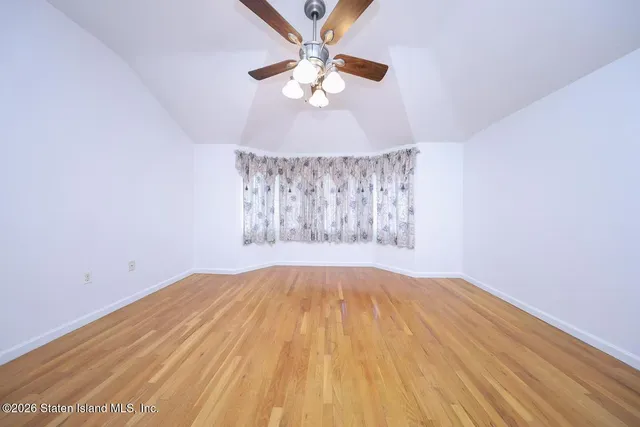 wooden floor in a hall with a window