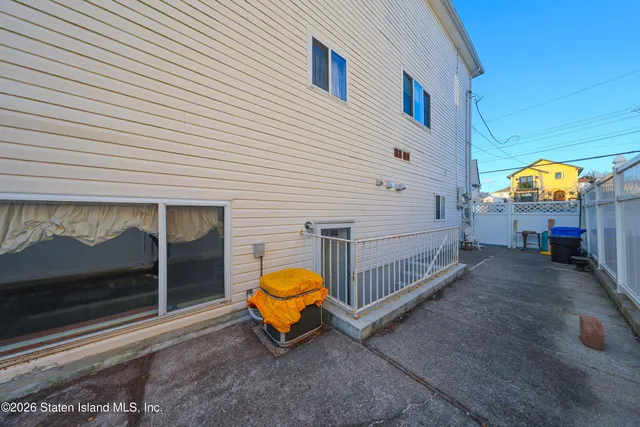 a view of a house with a table and chairs
