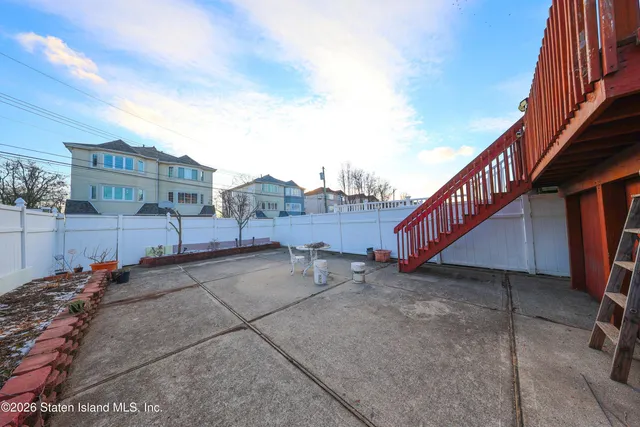a view of a street with wooden fence