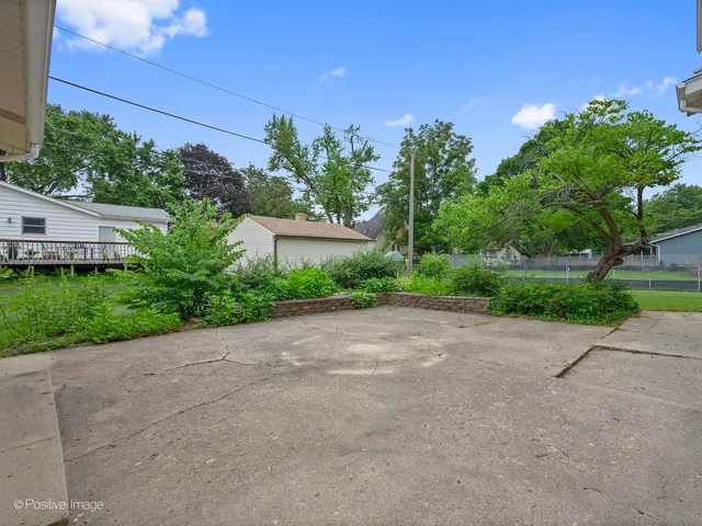 a view of a street with a house in the background