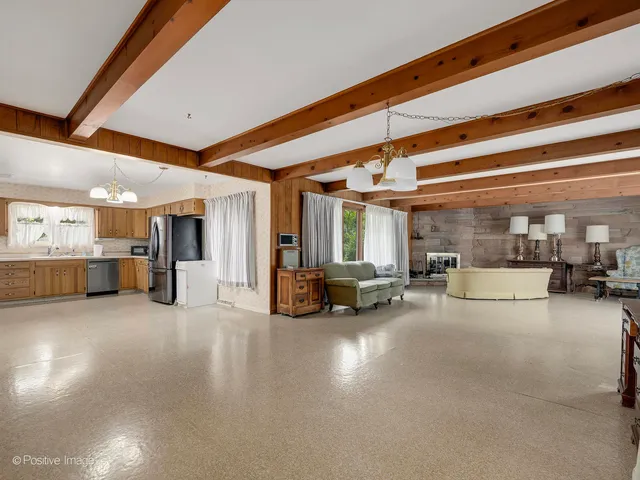 a view of a livingroom with furniture and a window