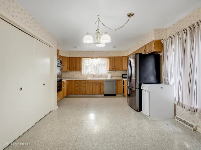 a view of a kitchen with a refrigerator a microwave and a sink