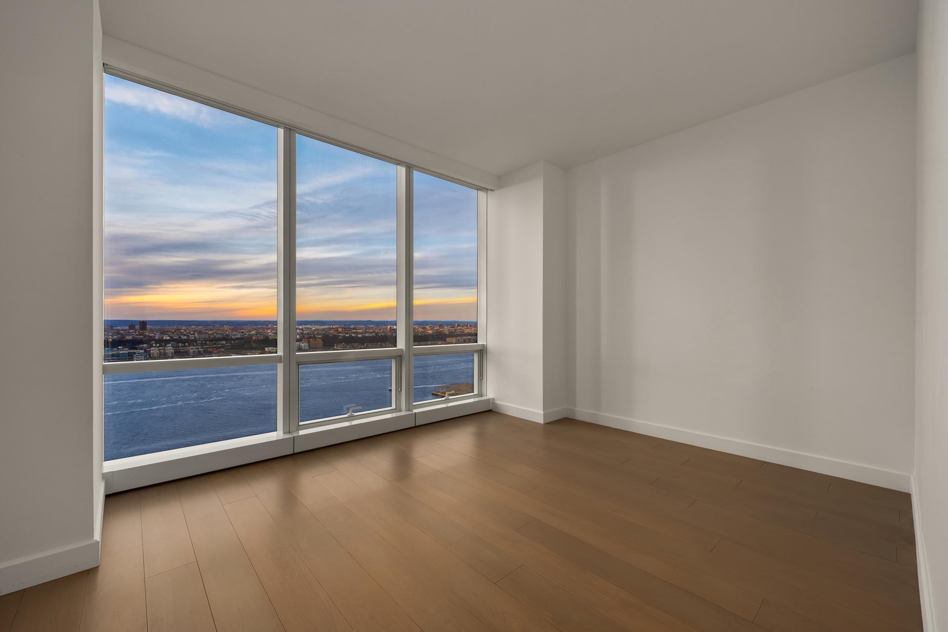 15 Hudson Yards, Unit 38C Manhattan, NY 10001 - Photo 10 of 31 an empty room with sliding door and wooden floor