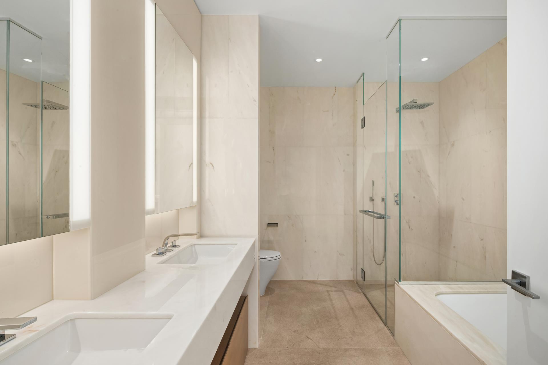 15 Hudson Yards, Unit 38C Manhattan, NY 10001 - Photo 11 of 31 a bathroom with a tub sink and mirror