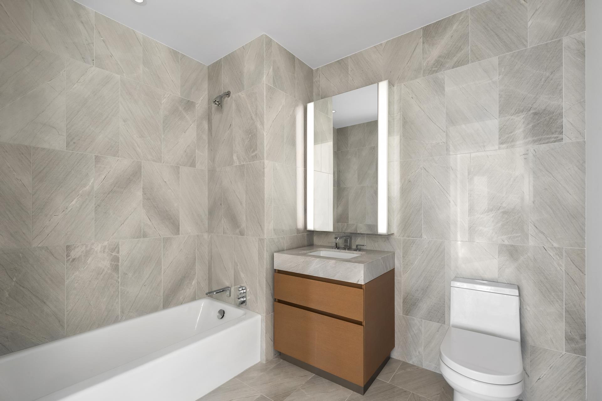 15 Hudson Yards, Unit 38C Manhattan, NY 10001 - Photo 14 of 31 a bathroom with a sink a toilet and shower