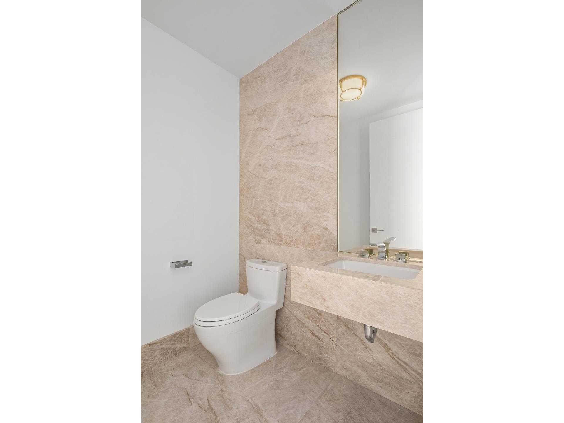 15 Hudson Yards, Unit 38C Manhattan, NY 10001 - Photo 15 of 31 a bathroom with a sink a toilet and shower