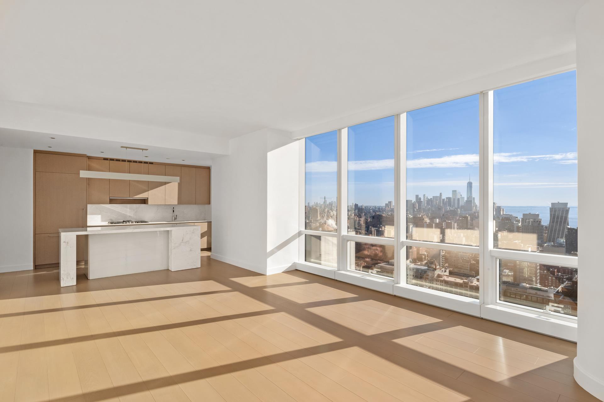 15 Hudson Yards, Unit 38C Manhattan, NY 10001 - Photo 4 of 31 a living room with a large window and a table