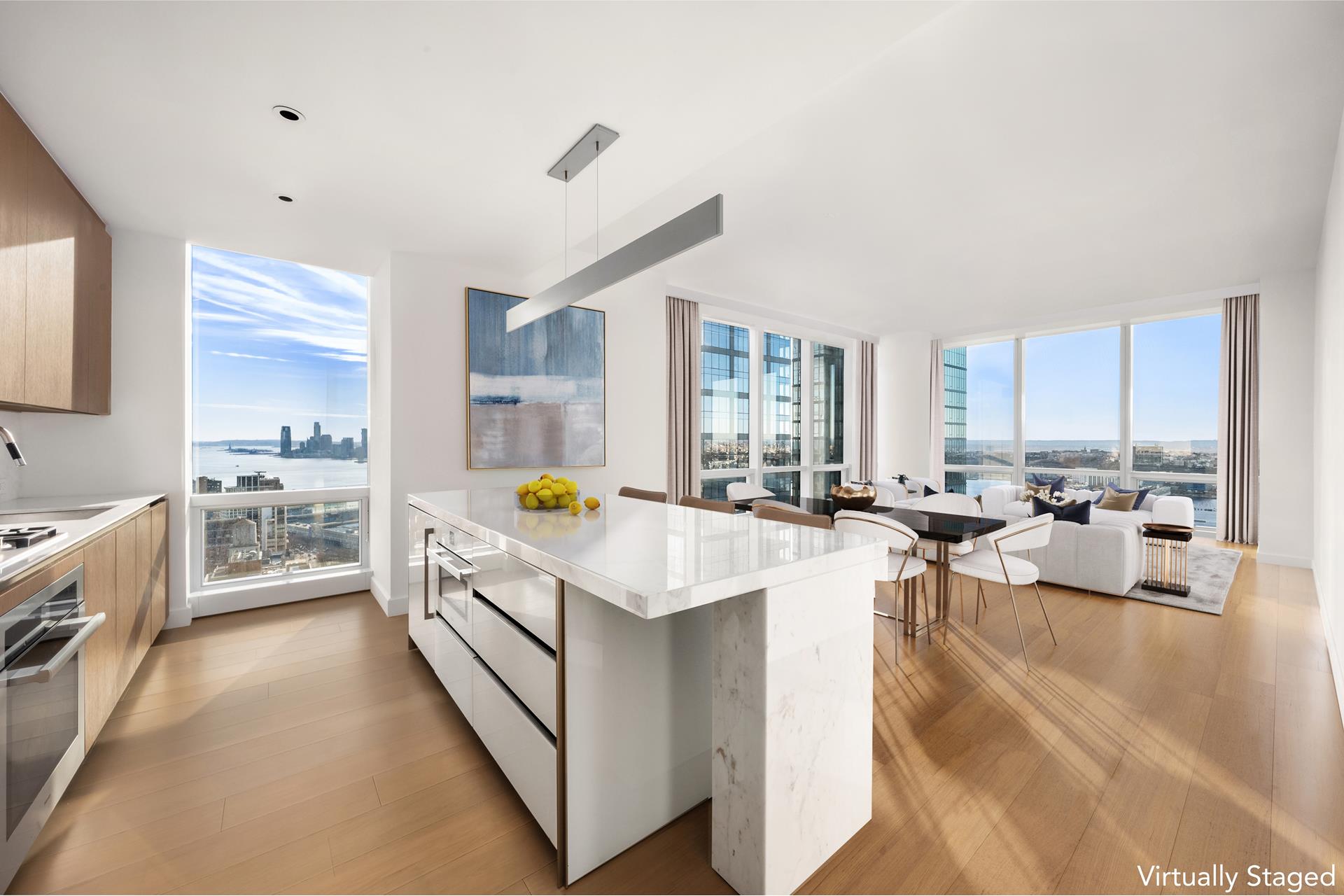 15 Hudson Yards, Unit 38C Manhattan, NY 10001 - Photo 6 of 31 a large white kitchen with lots of counter space a sink a window and chairs