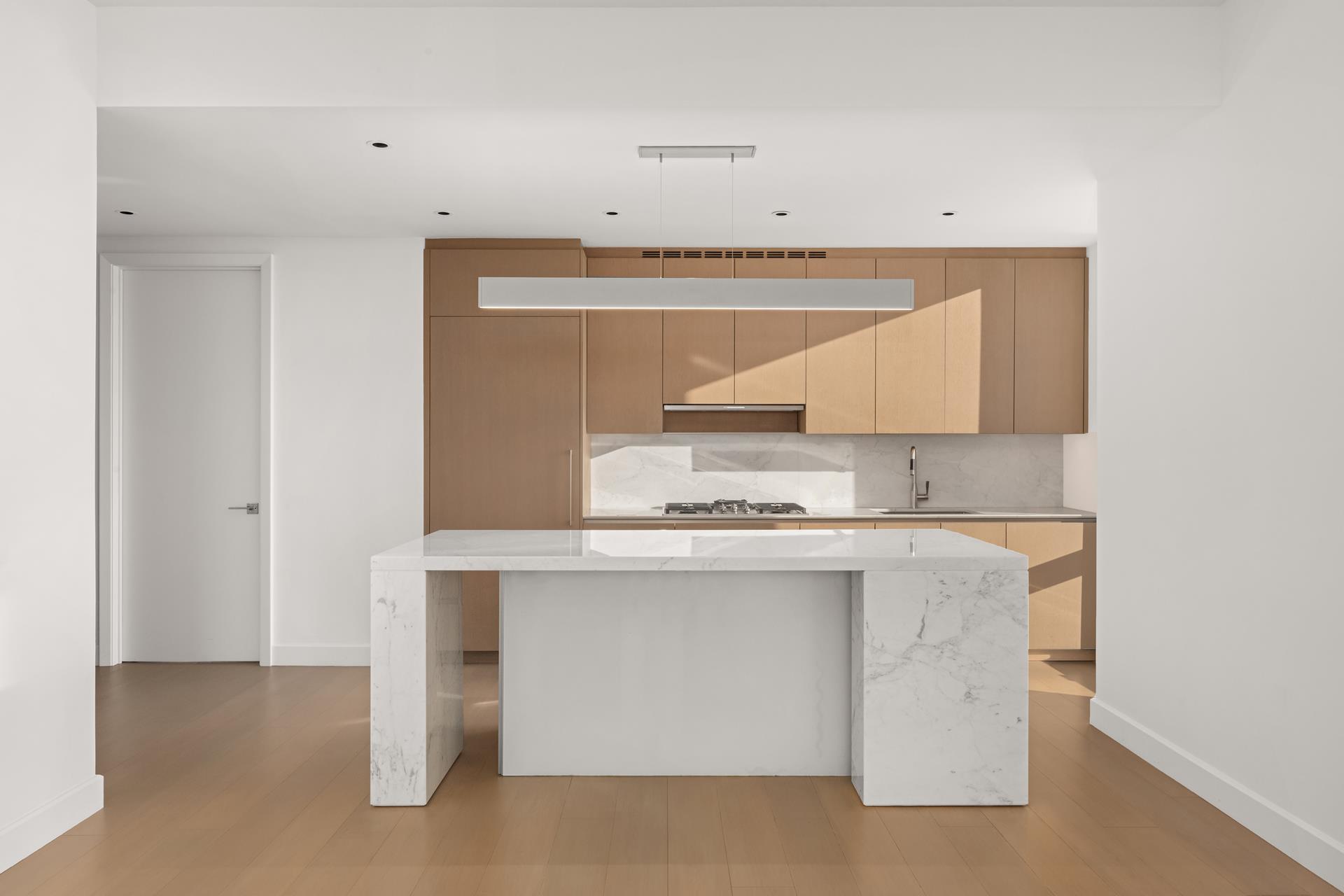 15 Hudson Yards, Unit 38C Manhattan, NY 10001 - Photo 8 of 31 a kitchen with stainless steel appliances a sink stove and cabinets