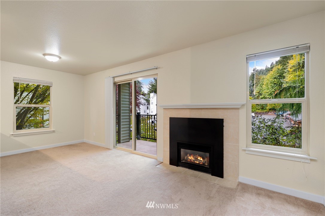 9805 Avondale Road Northeast, Unit L237 Redmond, WA 98052 - Photo 1 of 25 an empty room with windows and fireplace