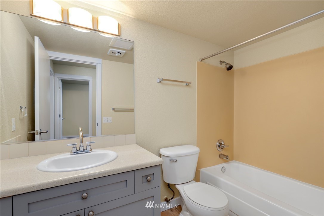 9805 Avondale Road Northeast, Unit L237 Redmond, WA 98052 - Photo 14 of 25 a bathroom with a sink a toilet and shower