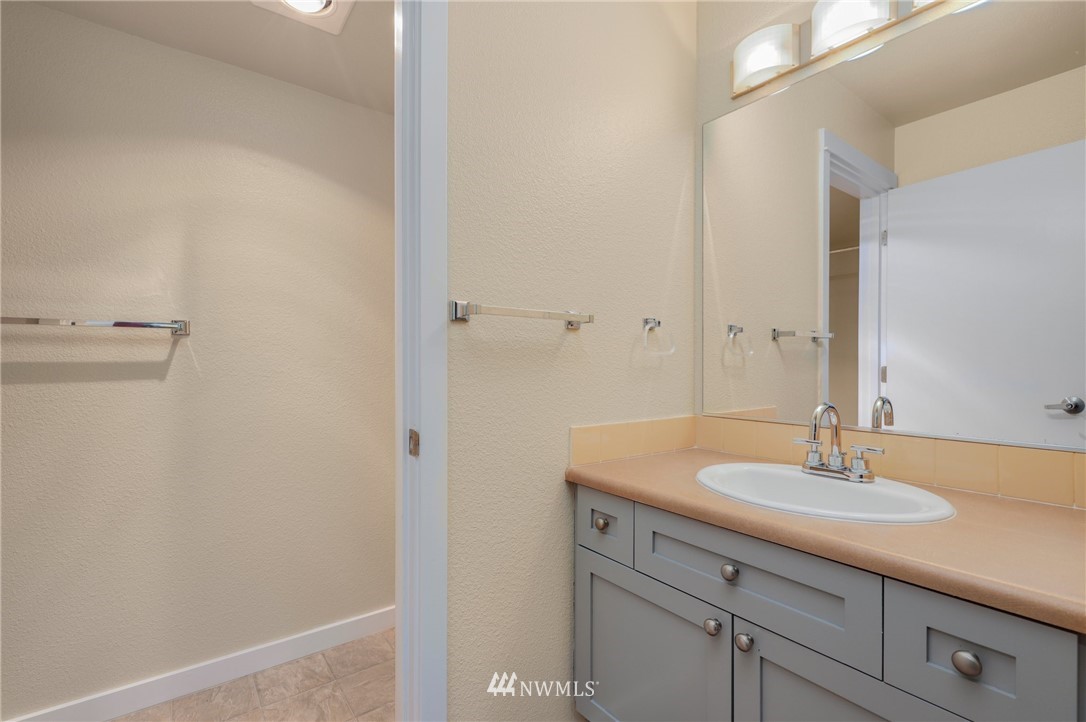 9805 Avondale Road Northeast, Unit L237 Redmond, WA 98052 - Photo 9 of 25 a bathroom with a sink and a mirror