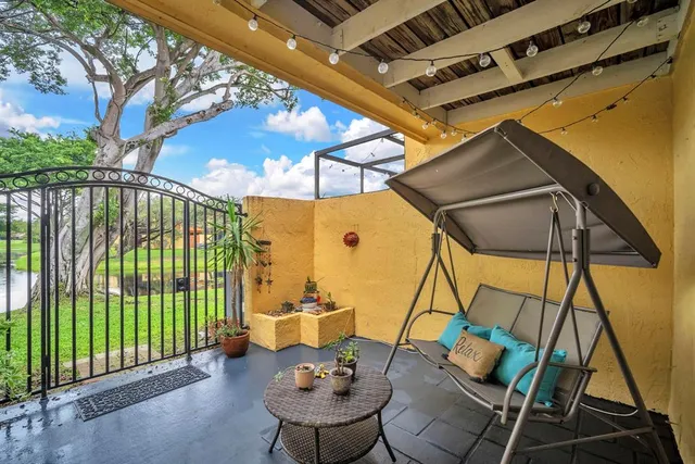 a backyard of a house with garden and outdoor seating