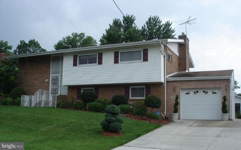 9311 Pella Place Clinton, MD 20735 - Photo 1 of 24 a front view of a house with garden