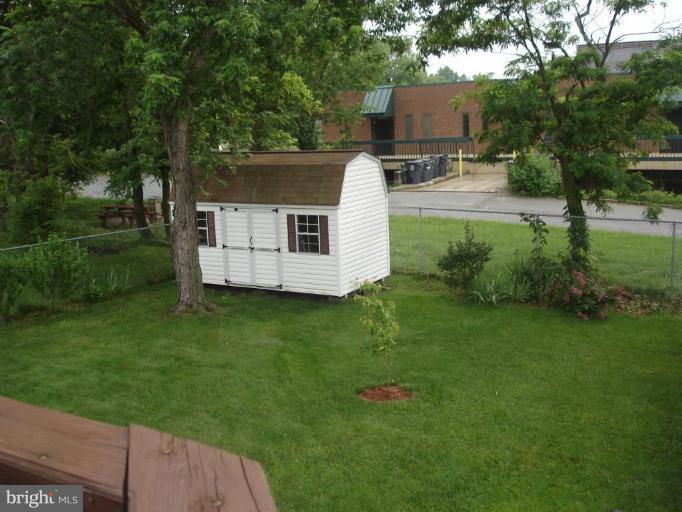 9311 Pella Place Clinton, MD 20735 - Photo 11 of 24 a view of a backyard with a house and garden