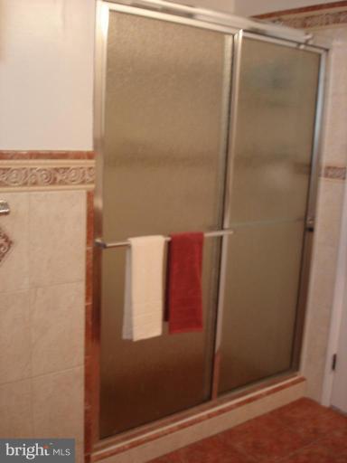 9311 Pella Place Clinton, MD 20735 - Photo 16 of 24 a bathroom with a glass shower door
