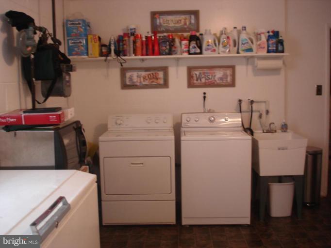 9311 Pella Place Clinton, MD 20735 - Photo 18 of 24 a utility room with dryer washer and shoe rack