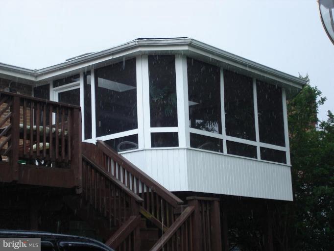 9311 Pella Place Clinton, MD 20735 - Photo 23 of 24 a view of wooden house with large windows and plants