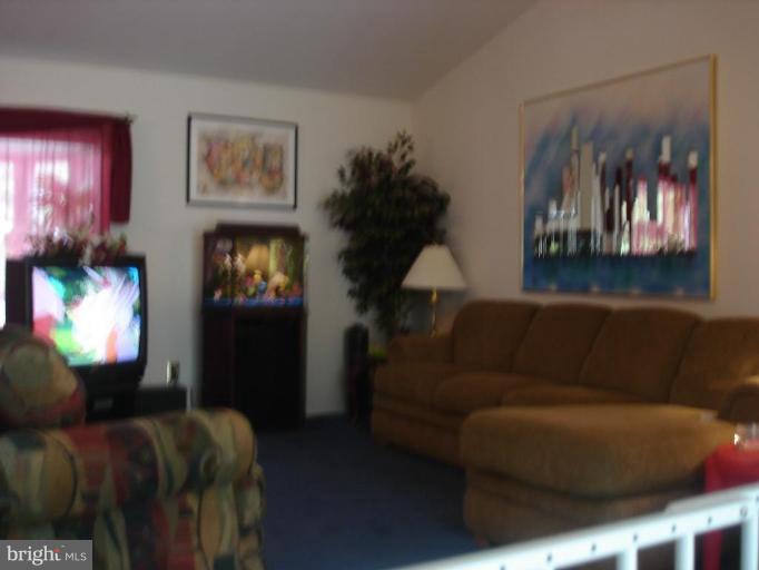 9311 Pella Place Clinton, MD 20735 - Photo 4 of 24 a living room with furniture and a lamp