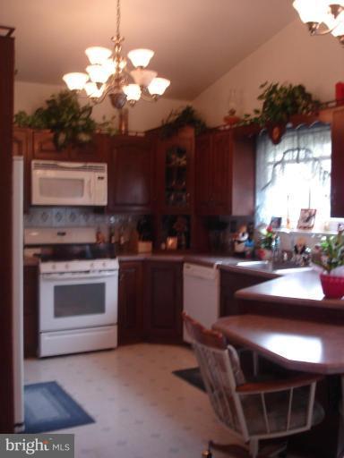 9311 Pella Place Clinton, MD 20735 - Photo 5 of 24 a kitchen with a stove a sink and a refrigerator