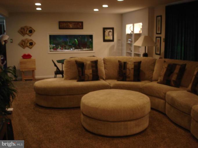 9311 Pella Place Clinton, MD 20735 - Photo 8 of 24 a living room with furniture and a flat screen tv