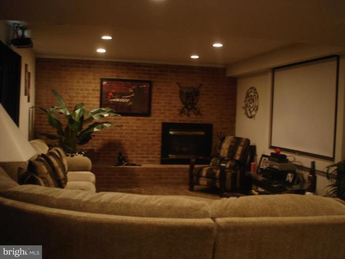 9311 Pella Place Clinton, MD 20735 - Photo 9 of 24 a living room with furniture and a fireplace