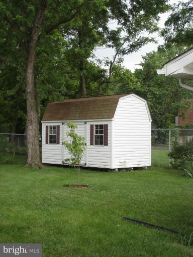 9311 Pella Place Clinton, MD 20735 - Photo 10 of 24 a view of a house with a backyard