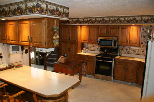 3617 Valerie Road Roscoe, IL 61073 - Photo 3 of 5 a kitchen with a stove a sink and a refrigerator