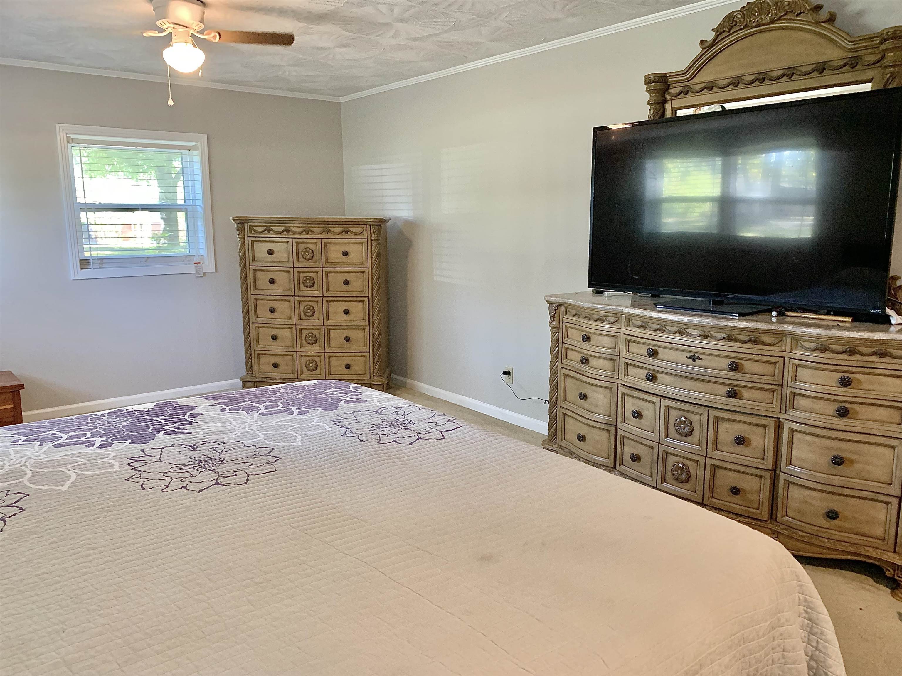 1038 Lake Street Bolivar, TN 38008 - Photo 14 of 31 Bedroom with light carpet, crown molding, and ceiling fan