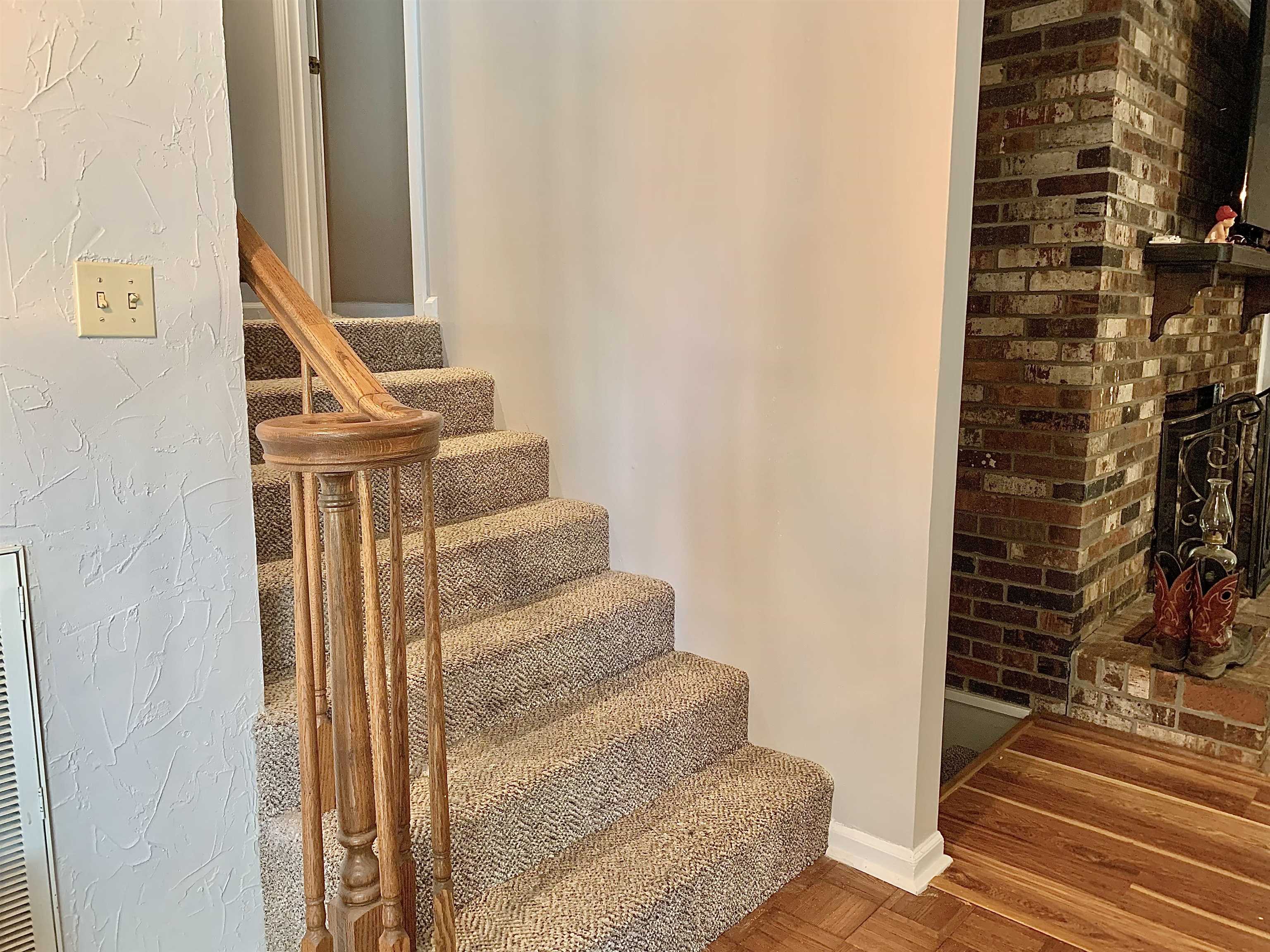 1038 Lake Street Bolivar, TN 38008 - Photo 18 of 31 Staircase featuring a fireplace