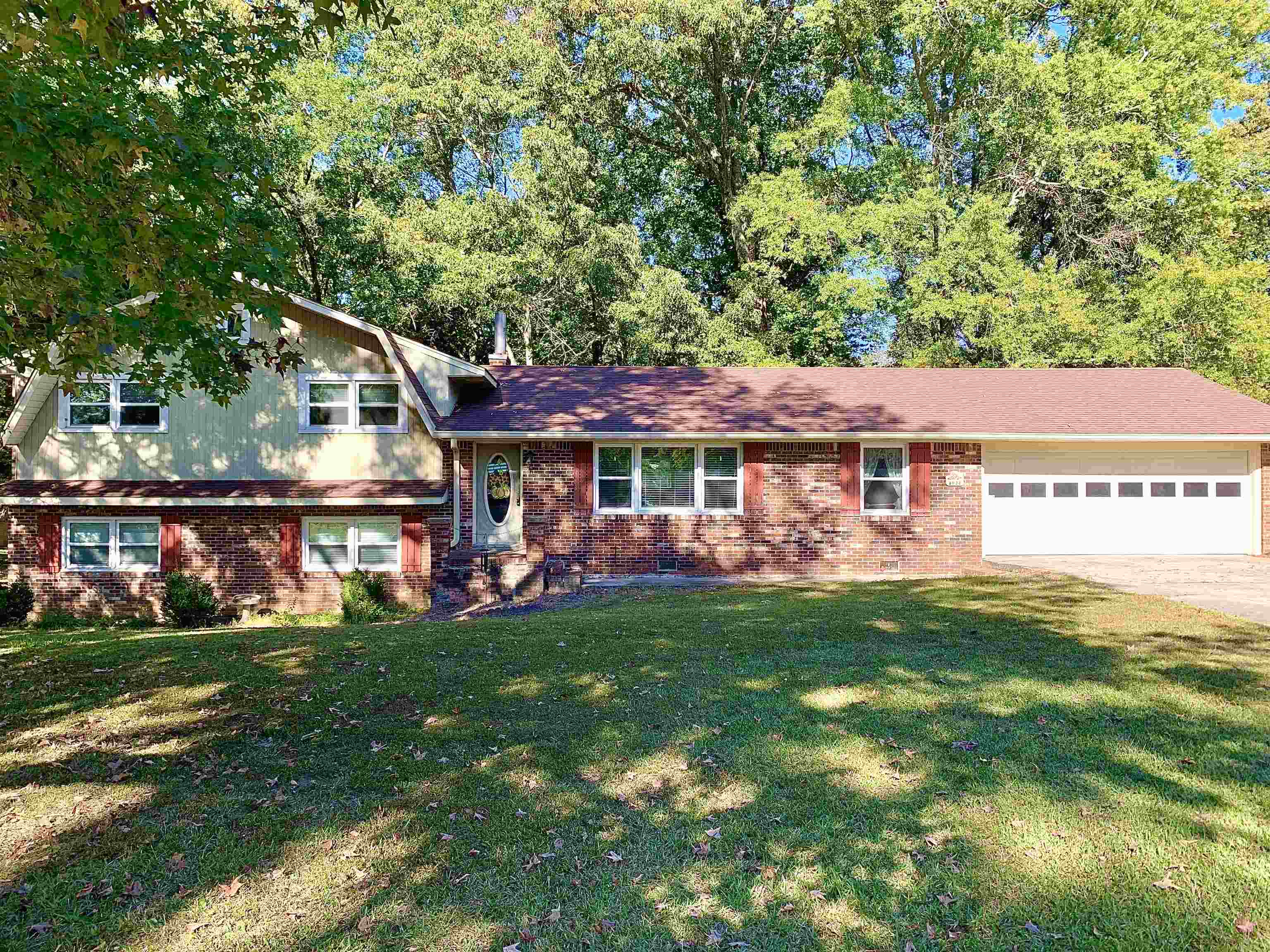 1038 Lake Street Bolivar, TN 38008 - Photo 2 of 31 Tri-level home featuring a garage and a front lawn