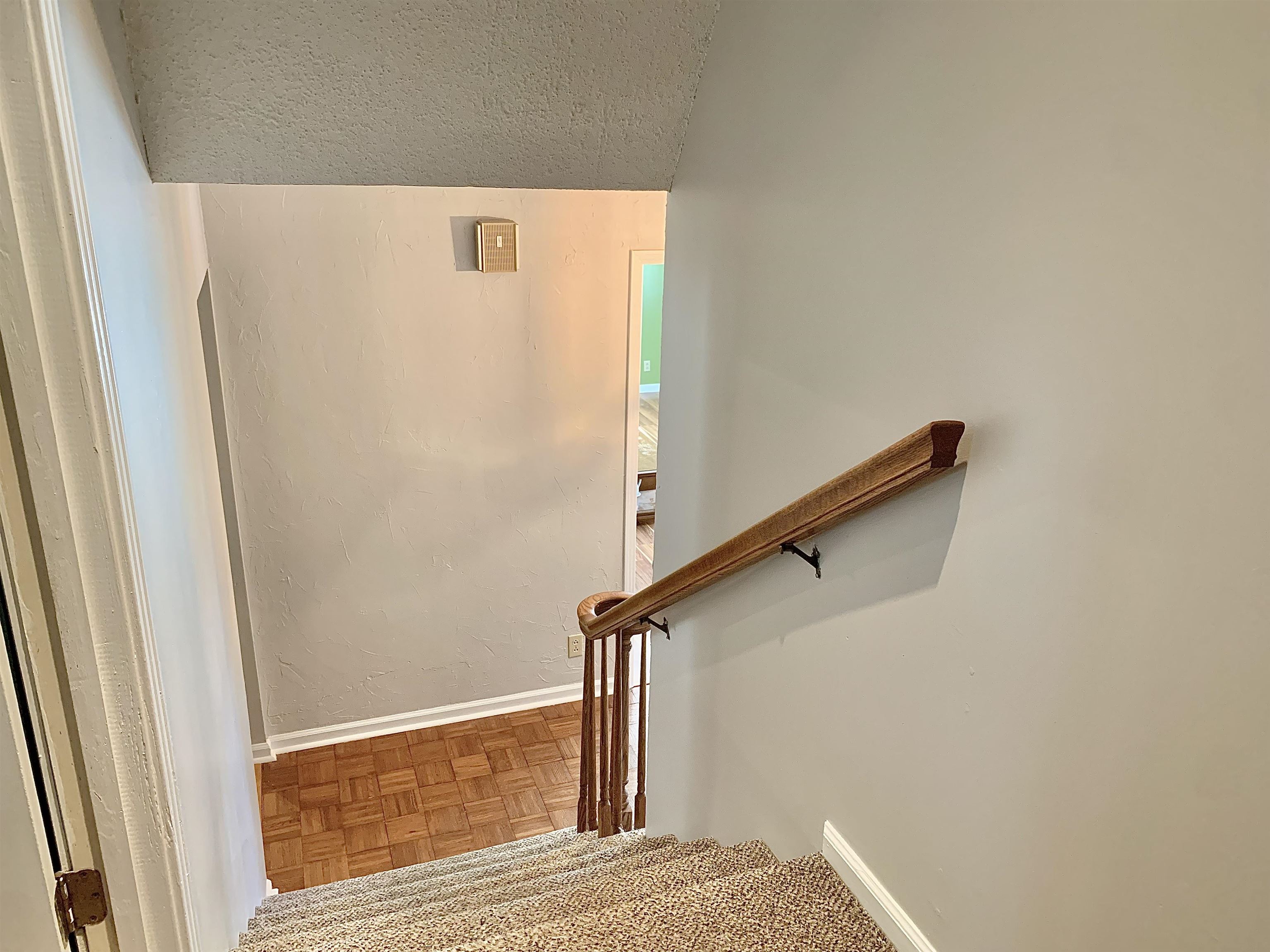 1038 Lake Street Bolivar, TN 38008 - Photo 24 of 31 Stairs featuring lofted ceiling, a textured ceiling, and parquet floors